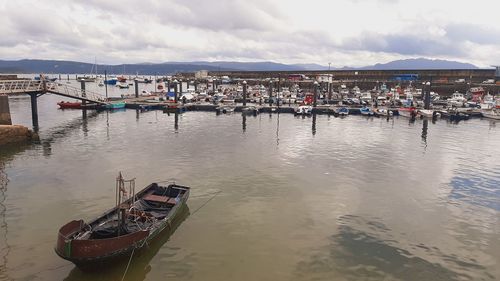 Boats moored in sea against sky