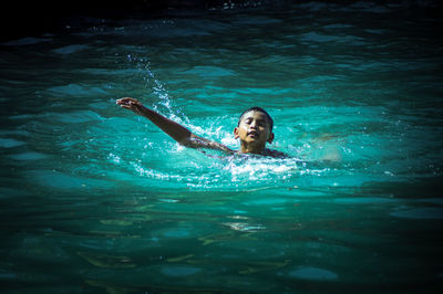 Portrait of woman swimming in pool