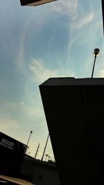 Low angle view of building against cloudy sky