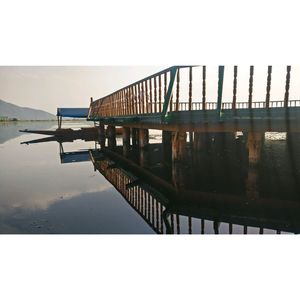 Pier on lake against clear sky