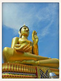 Low angle view of statue against blue sky