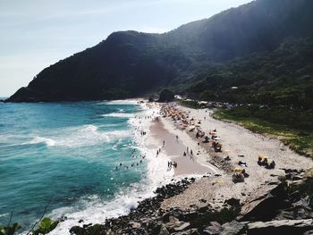 High angle view of people on mountain by sea