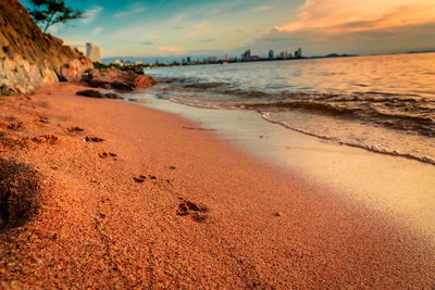 Scenic view of beach against sky during sunset