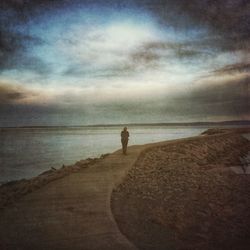 Scenic view of sea against cloudy sky