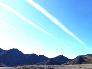 Low angle view of mountain range against blue sky