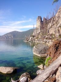 Scenic view of sea and mountains against sky