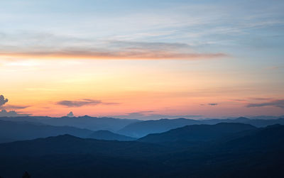 Scenic view of silhouette mountains against sky during sunset