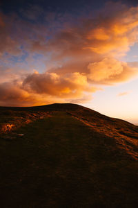 Scenic view of field against sky during sunset