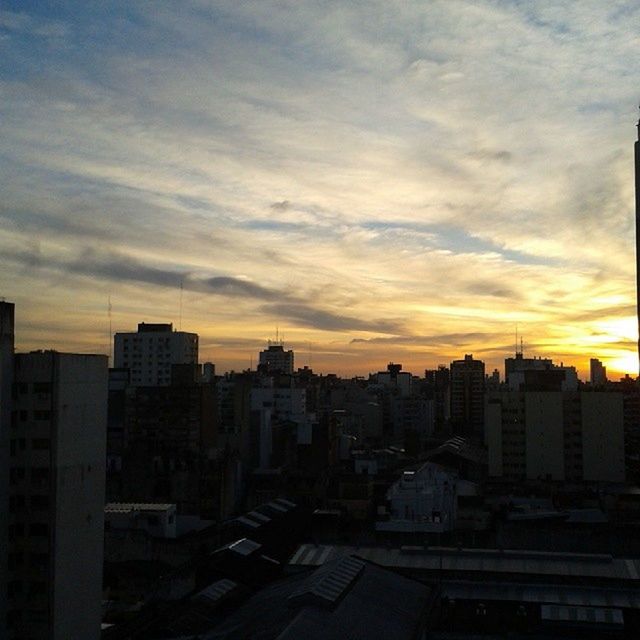 building exterior, architecture, sunset, built structure, city, cityscape, sky, cloud - sky, residential building, orange color, residential district, residential structure, silhouette, high angle view, crowded, city life, cloud, building, outdoors, dusk