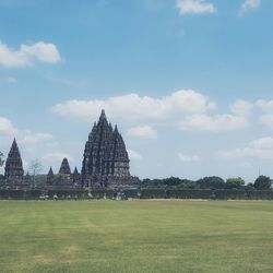 Silhouette of temple against cloudy sky