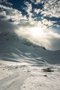 Scenic view of snow covered mountains against sky