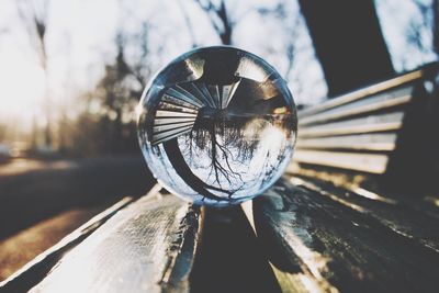 Close-up of crystal ball on wooden post