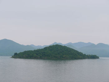 Scenic view of lake and mountains against clear sky