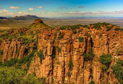 View of rock formations against cloudy sky