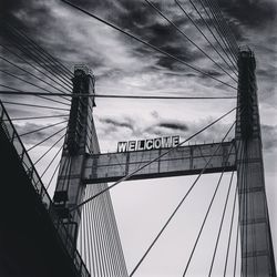 Low angle view of suspension bridge against sky