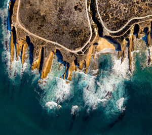 Aerial view of cave by sea