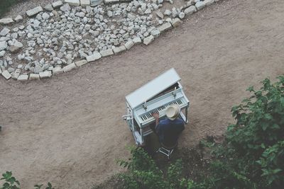 High angle view of man playing piano outdoors