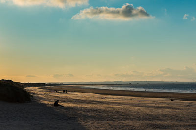 Scenic view of beach against sky during sunset