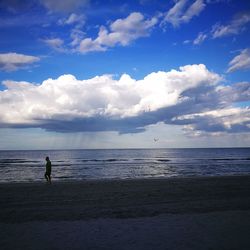 Scenic view of beach against blue sky