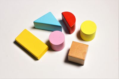 High angle view of multi colored pencils on white background