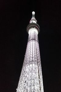 Low angle view of illuminated tower against sky at night