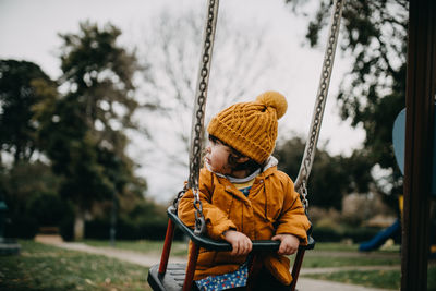 Low section of boy on swing in playground