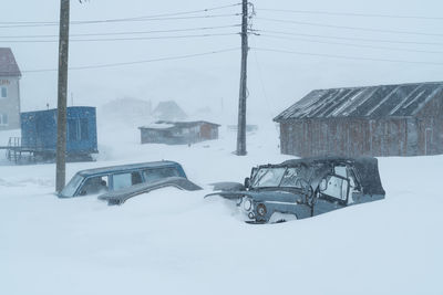 Built structure on snow covered buildings against sky