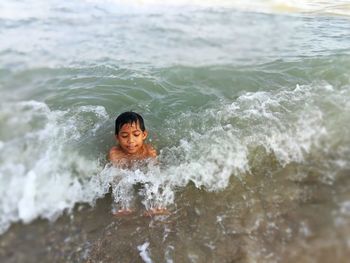 Portrait of boy swimming in sea