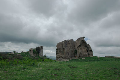 Rocks on land against sky