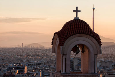View of buildings in city at sunset