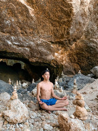 Young woman sitting on rock