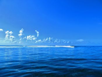 Scenic view of sea against blue sky