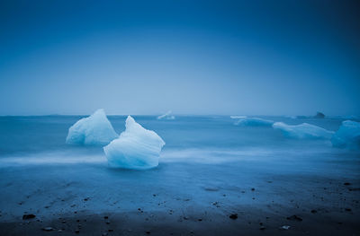 Scenic view of frozen sea against clear sky