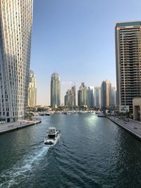 Modern buildings in city against clear sky