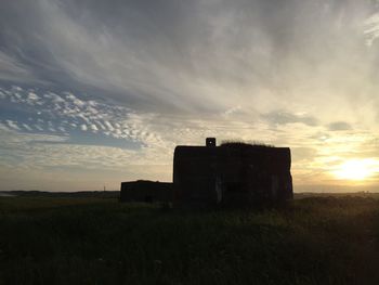 Scenic view of landscape against cloudy sky