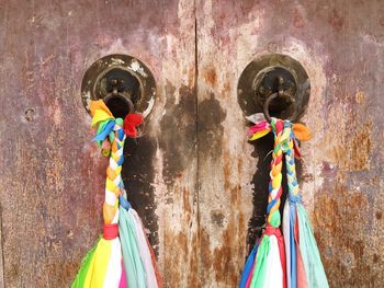 Close-up of fabric decorations on door knocker