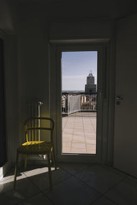 Chairs and table by window in building