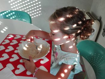 High angle view of girl on balloons
