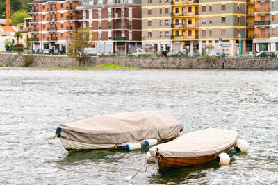 Rear view of woman sitting in boat in river