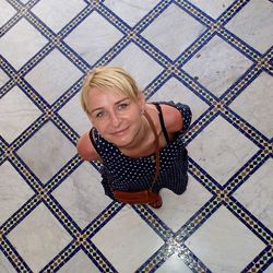 Directly above portrait of smiling woman standing indoors