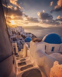 Buildings by sea against sky during sunset at santorini