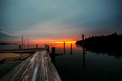 Pier on sea at sunset