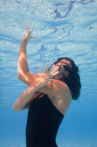 Female model swimming in pool