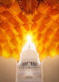 Low angle view of illuminated building against sky