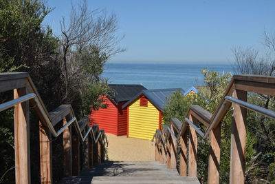 High angle view of steps leading beach houses against sky