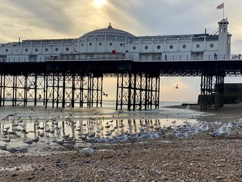 Pier on beach against sky