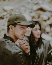 Portrait of young man looking away outdoors