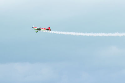 Low angle view of airplane flying against sky