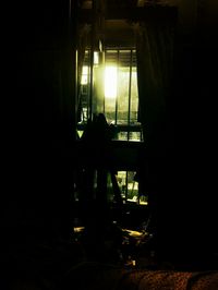 Silhouette of man in window