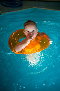 High angle view of boy swimming in pool